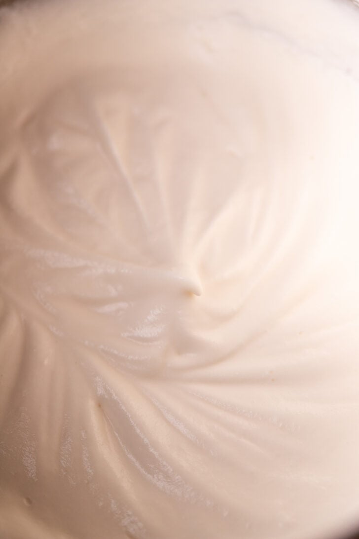 Soft peaks whipped cream in a bowl.