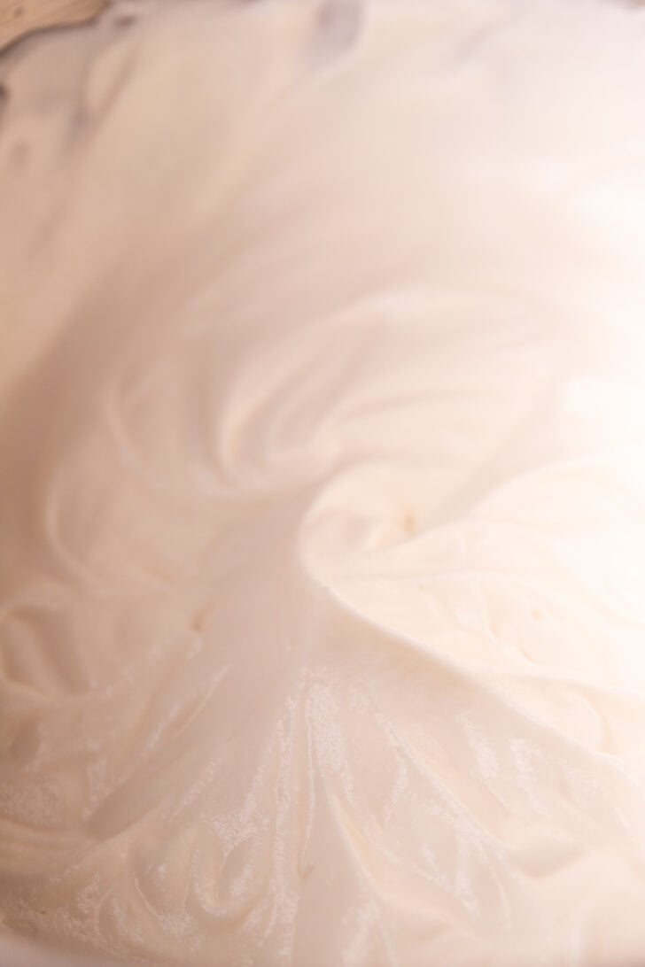 Medium peaks whipped cream in a bowl.