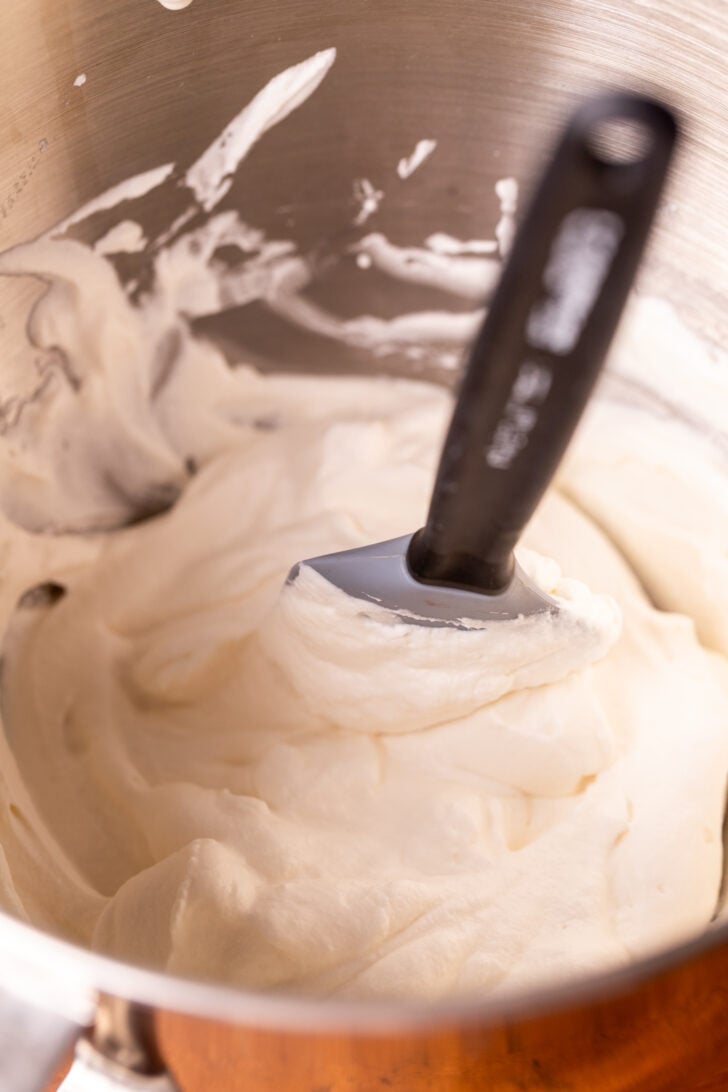 Stiff peaks whipped cream in a bowl.