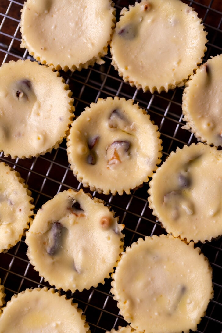Baked cheesecakes on a wire rack.