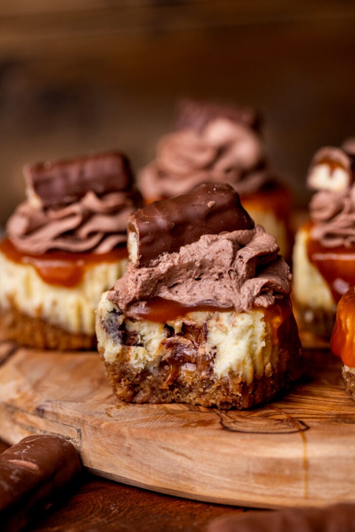Bite missing from Twix mini cheesecakes.